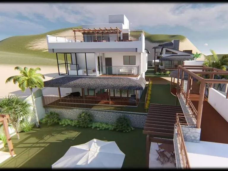Casa implantada em plataformas na encosta, com deques de madeira